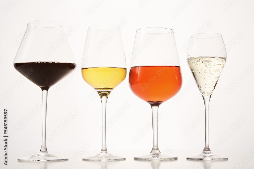 Pink, white, red, sparkling alcoholic drinks in wine glasses.