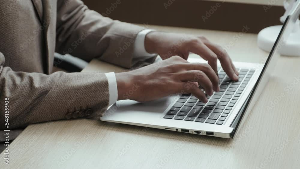 Close up shot of hands of unrecognizable businessman typing on laptop at office workplace Close up shot of hands of unrecognizable businessman typing on laptop at office workplace