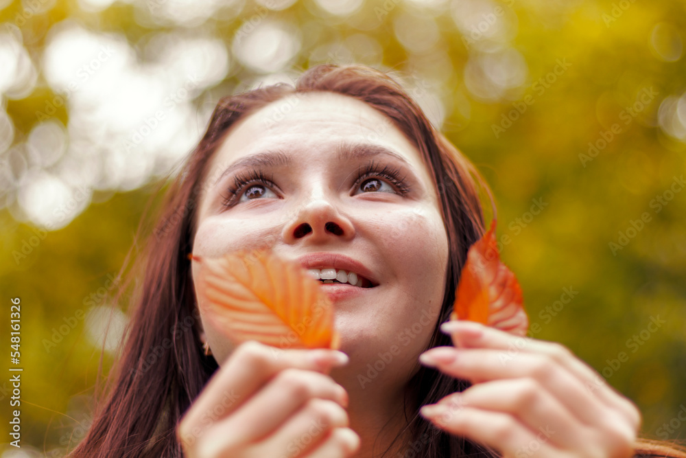 Happy smiling young woman in park on autumn day. Happy smiling young woman in park on autumn day.