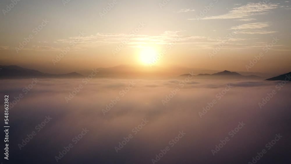 Amazing rising drone shot in between clouds of a sunrise in the hills of the desert of Lima Amazing rising drone shot in between clouds of a sunrise in the hills of the desert of Lima