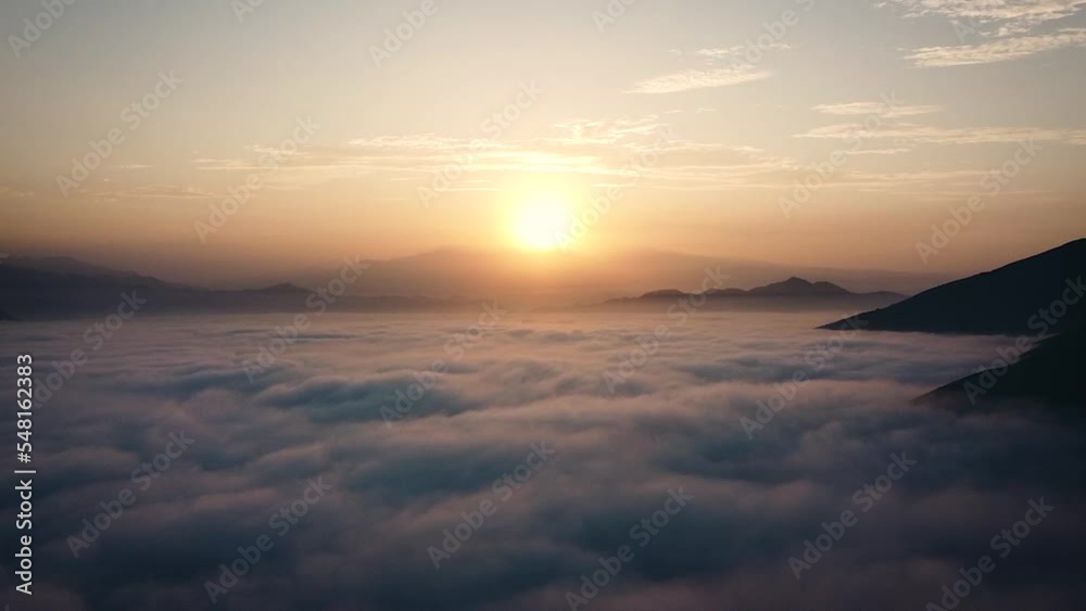 Amazing drone shot of a sunrise above a mattress of clouds in the mountains of Lima Peru Amazing drone shot of a sunrise above a mattress of clouds in the mountains of Lima Peru
