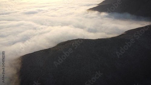 Sunrise drone shot of mountains in between a mattress of clouds in Lima Peru photo