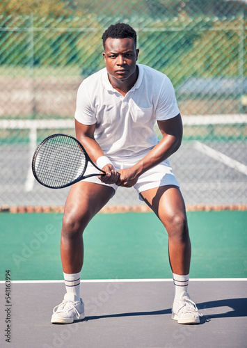 Tennis, sports and black man in portrait for game, competition and training with focus, power and energy wellness. Strong, athlete and fitness african in tennis court for outdoor body exercise © L Ismail/peopleimages.com