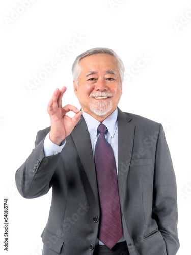 Asian senior businessman , old man with suit and tie showing ok gesture hand standing and looking at camera isolated on white background with copy space - lifestyle senior male concept