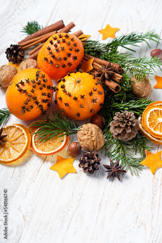 Christmas decor. dried orange slices, nuts, spices, conces, fresh oranges decorated cloves on wooden table close up. Christmas holiday. festive winter season. 