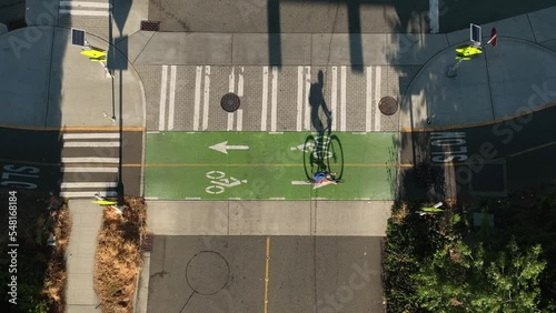 Top down view of a cyclist passing through a vacant intersection using the bike lane.