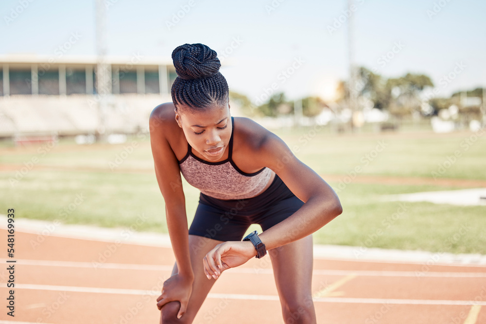 Black woman, fitness and runner checking watch for monitoring exercise, workout or sports track time. Active African American female looking at smart watch in running sport for performance tracking