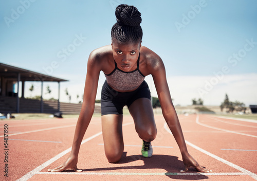 Fototapeta Naklejka Na Ścianę i Meble -  Black woman, runner and start line, race and competition, exercise challenge or fitness at stadium arena. Portrait, focus and sports athlete ready on running track, marathon training and cardio power