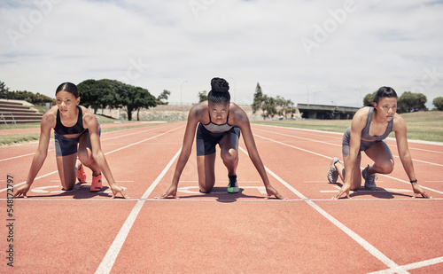 Women, runner and start race, training and fitness on sports track, running and ready with motivation, healthy and workout. Diversity, challenge and energy for speed run, exercise and competition photo