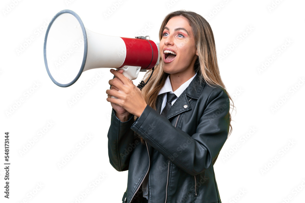 Business pretty Uruguayan woman wearing a biker jacket over isolated background shouting through a megaphone Business pretty Uruguayan woman wearing a biker jacket over isolated background shouting through a megaphone