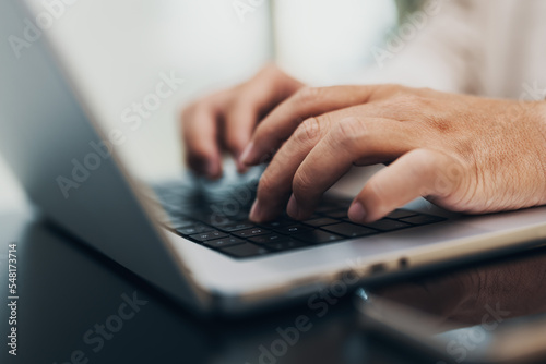 closeup of hands typing on a notebook, keyboard