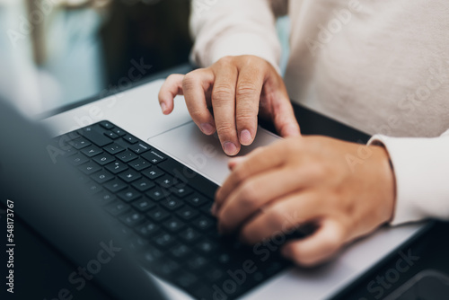 closeup of hands typing on a notebook, keyboard