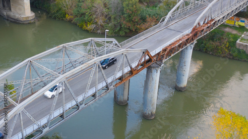 Aerial view of Ponte dell'Industria, also known as Ponte di Ferro or Iron bridge. It is a bridge that connects the neighborhoods Ostiense and Portuense. Under the bridge passes the Tiber river. photo