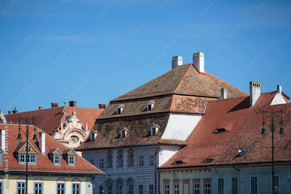 Different roof designs in sibiu town. Vintage eastern european building details. Historical red roof tiles.