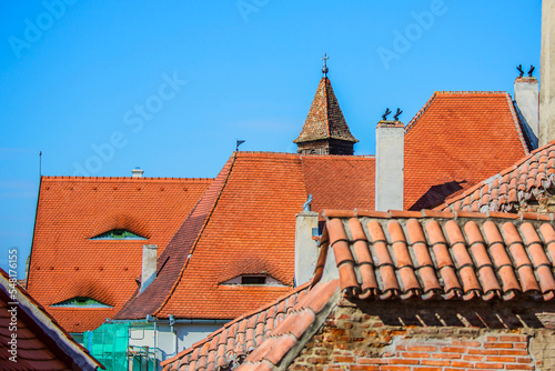 Vintage red tiled roofs in Sibiu town Romania. Old historical architecture in Europe.