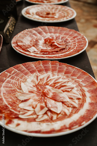 Plate with Iberian cut ham. Spanish jamon iberico (ham). Selective focus point photo