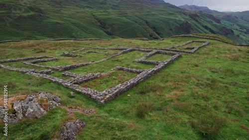 Aerial flyover - ancient Hardknott Roman Fort in scenic Cumbria countryside, UK photo