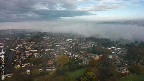 Aerial Drone Hyperlapse on Foggy Morning with Mist Moving Through Valley and Sunny Rays Over Fields in Calverley Village Leeds West Yorkshire UK photo
