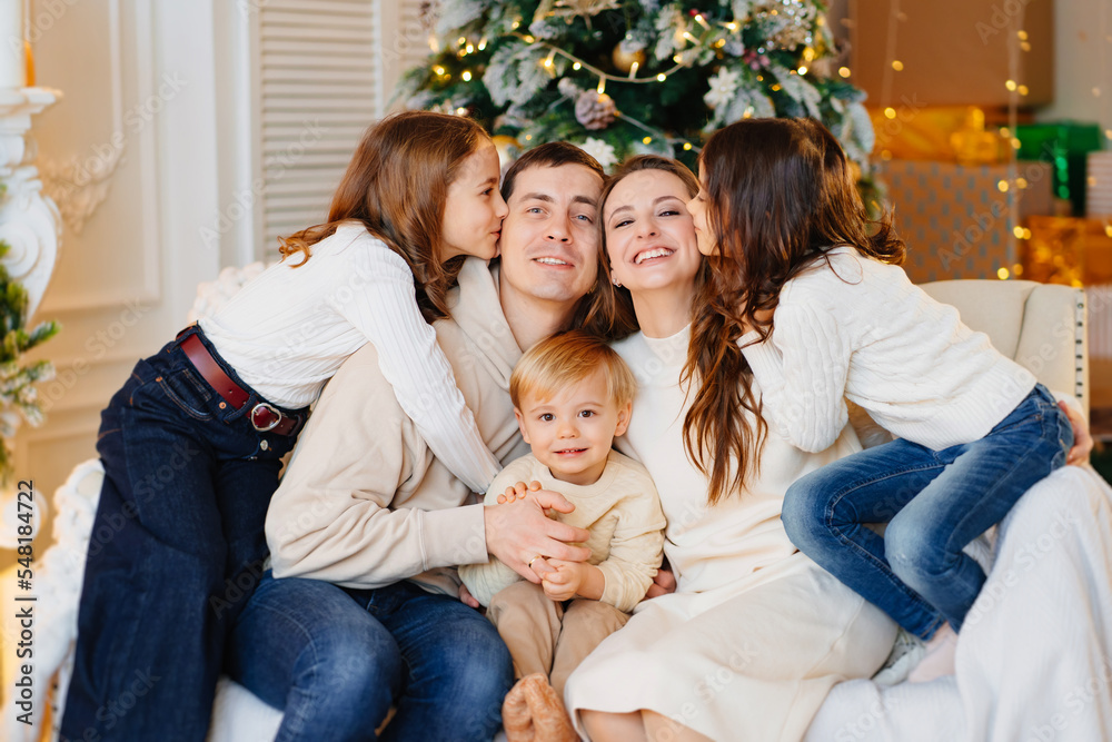 Beautiful happy large family on the couch by the Christmas tree. Beautiful happy large family on the couch by the Christmas tree.