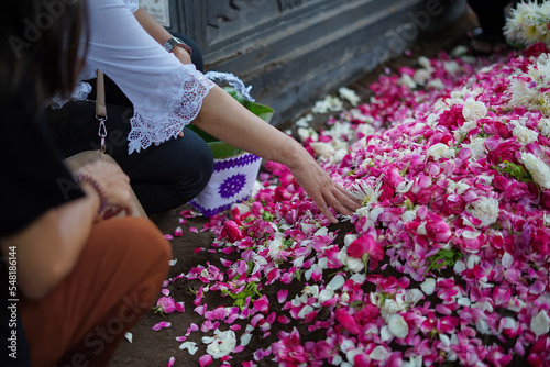 Photography Selective focus on sprinkling flowers at a funeral.