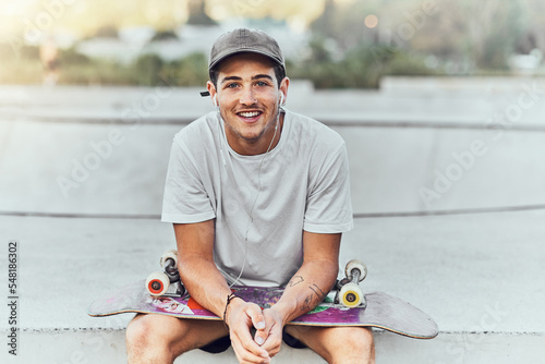 Bilde på lerret Young man, skateboard and skater with music at urban skate park, youth and recreation with earphones for audio streaming