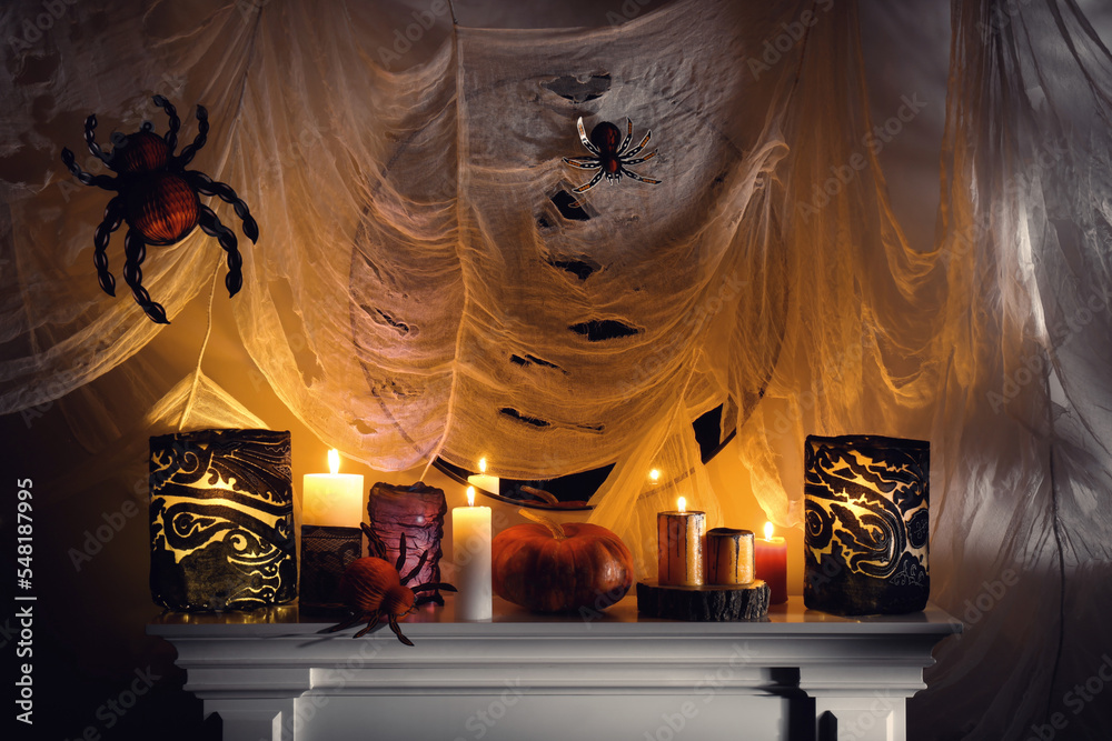 Fototapeta premium Different Halloween decor on fireplace indoors. Festive interior