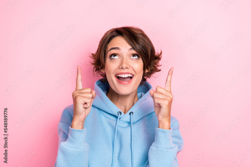 Photo of young adorable pretty cute nice woman wear blue hoodie curious look up interested new offer isolated on pink color background Photo of young adorable pretty cute nice woman wear blue hoodie curious look up interested new offer isolated on pink color background