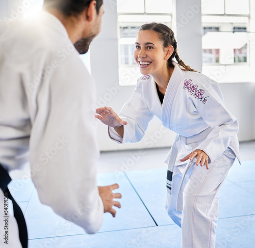 Karate, fitness and teacher with student, combat sports and training for skill development, power and discipline in dojo gym. Fight, happy in taekwondo class and martial arts with sport exercise. photo