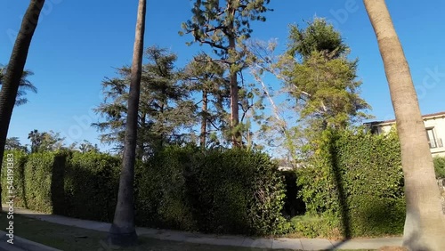 Driving POV passing wealthy exclusive Beverly hills, the Flats private home exterior