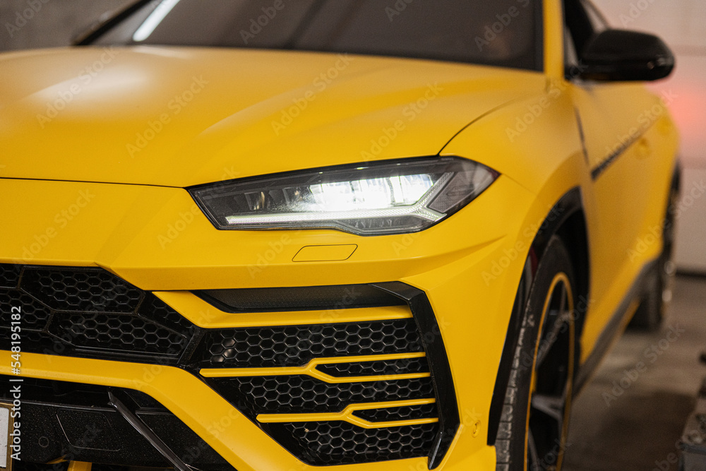 Fototapeta premium Headlights of yellow sport car suv.