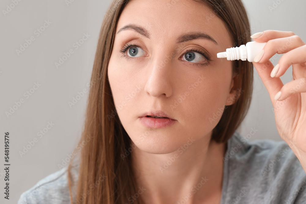 Beautiful woman using eye drops at home, closeup Beautiful woman using eye drops at home, closeup