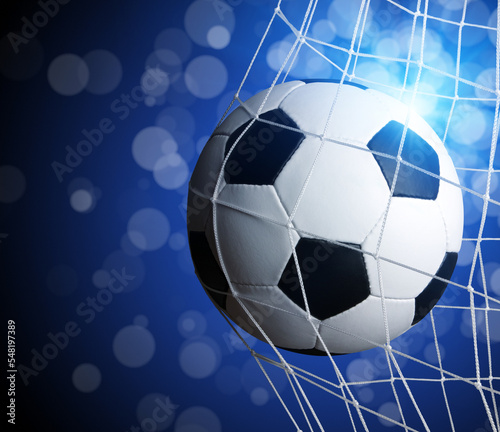 Soccer ball in goal on blue © Alekss