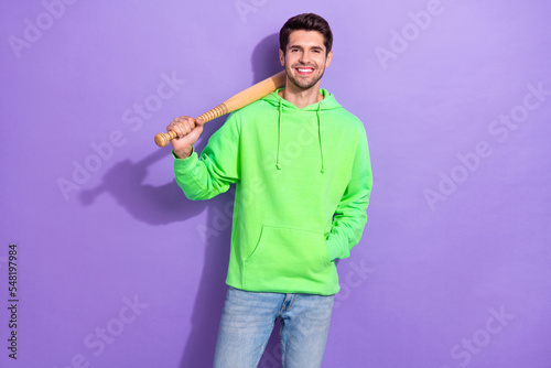 Canvas Print Photo of positive dangerous guy with brunet hairdo dressed green hoodie hold bas