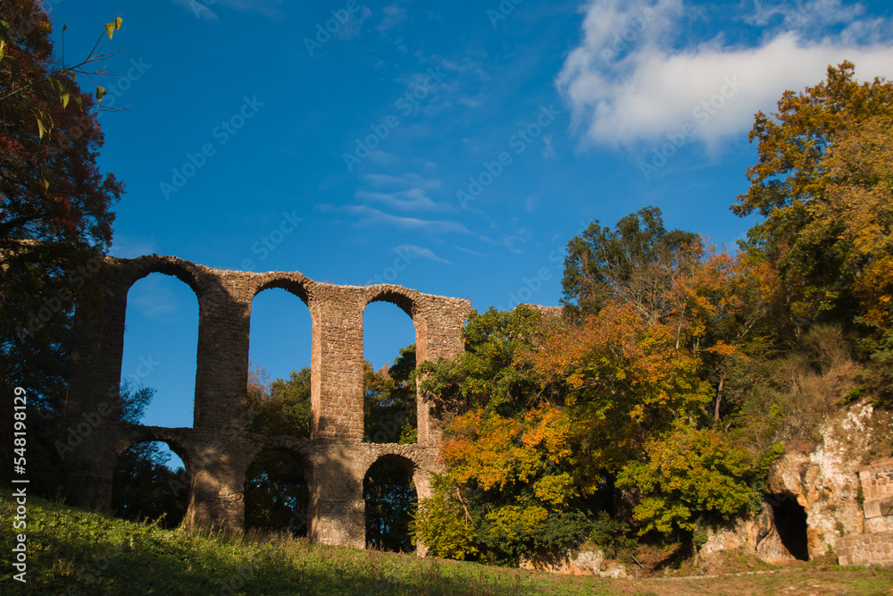 View aqueduct of Monterano Natural Reserve . A ghost medieval city in the country of Lazio region province of Rome, Monterano, born in Etruscan times on top of a small tuff hill, Italy
