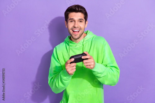 Photo of young hipster student man addicted player console sony playstation wireless joystick crazy look you isolated on violet color background