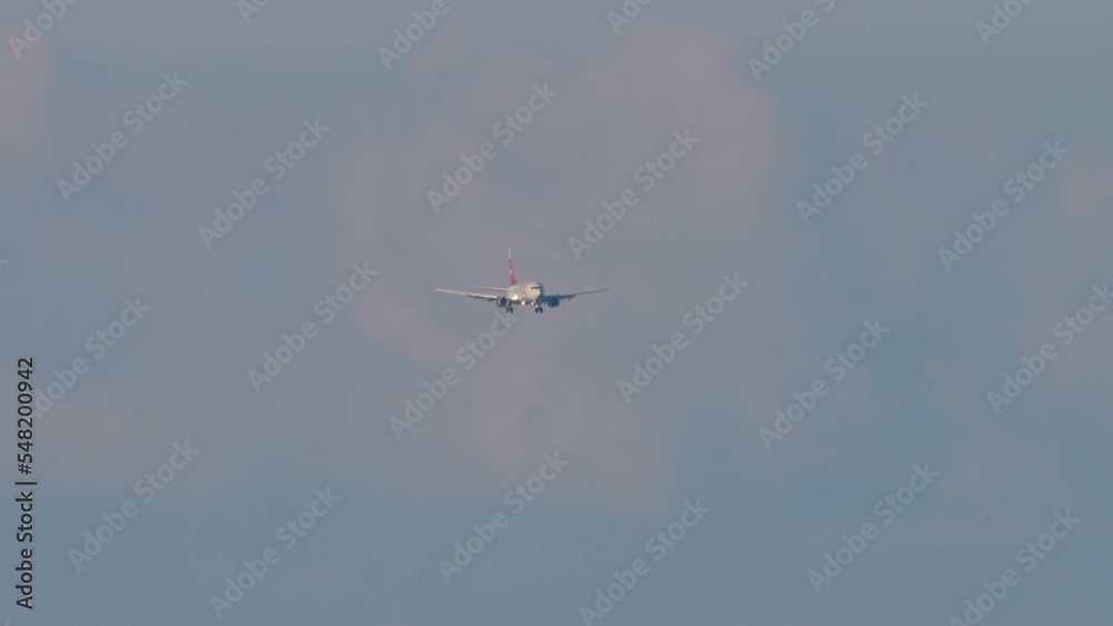 Passenger plane approaching for landing, front view long shot. Tourism and travel concept Passenger plane approaching for landing, front view long shot. Tourism and travel concept