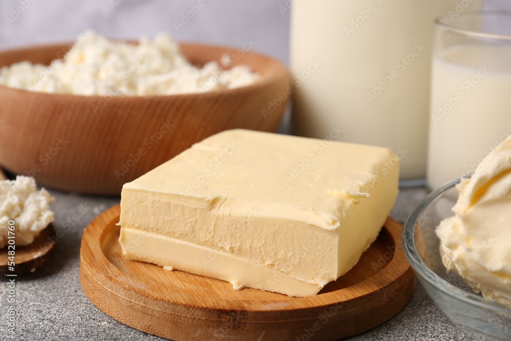 Piece of tasty homemade butter and dairy products on grey table, closeup