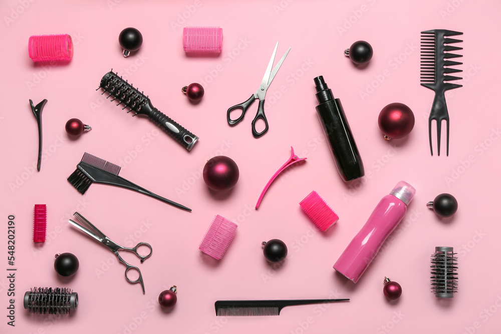 Hairdresser's tools with Christmas balls on pink background