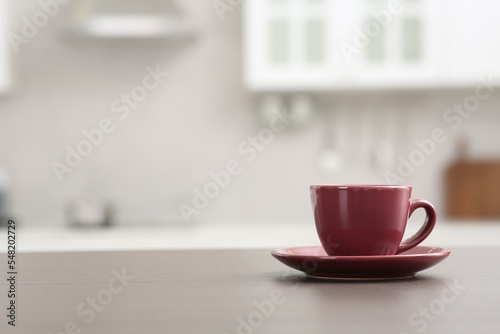 Cup of drink on counter in kitchen, space for text