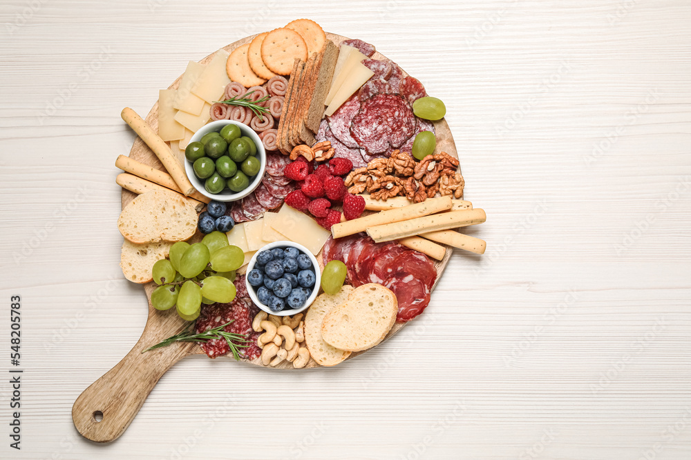 Tasty parmesan cheese and other different appetizers on white wooden table, top view. Space for text