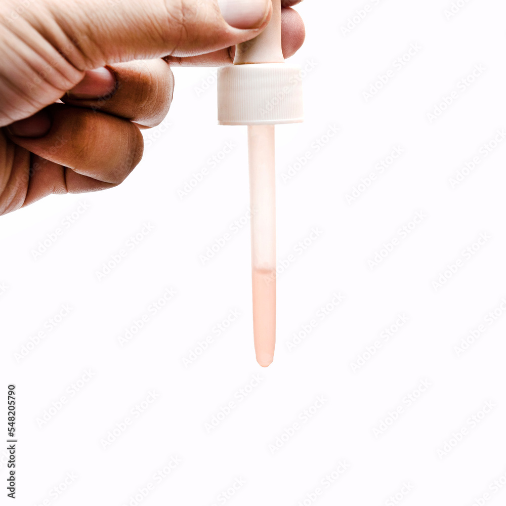 hand hold a spuit medicine pipette with liquid inside isolated white