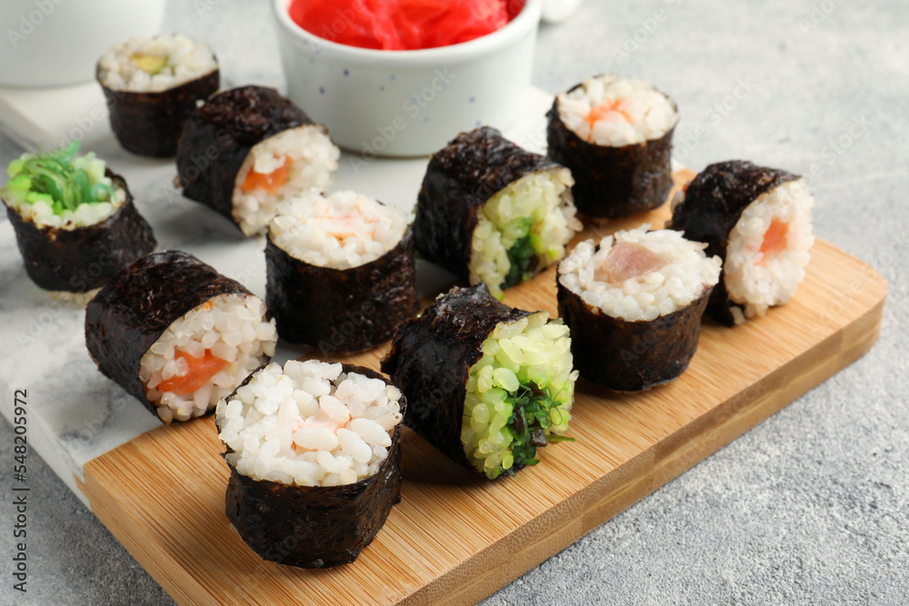 Tasty sushi rolls served on grey table, closeup Tasty sushi rolls served on grey table, closeup