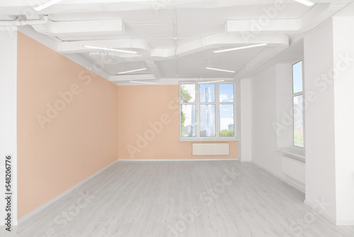 New empty office room with clean windows and beige walls