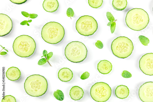 Fresh cucumber slices and mint leaves on a white background, overhead flat lay shot. Healthy organic food pattern