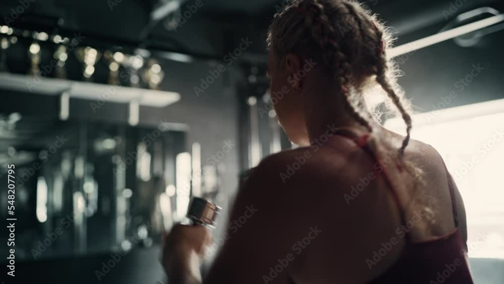 An Agile Sportswoman Doing Her Early Morning Cardio and Endurance Exercises. Portrait of a Boxing Female Champion Training and Improving her Punches Workout in an Empty Dark Gym. Dynamic Handheld Shot