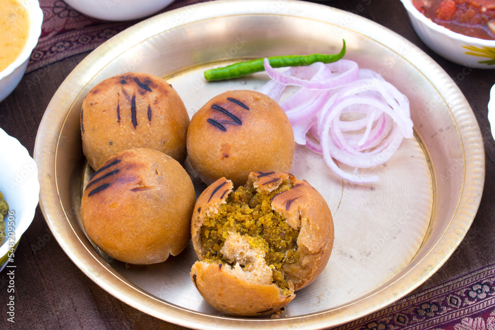 Litti with onion, chilli and chokha in brass plate. It is popular in Bihar, Uttar Pradesh and Jharkhand. Litti with onion, chilli and chokha in brass plate. It is popular in Bihar, Uttar Pradesh and Jharkhand.