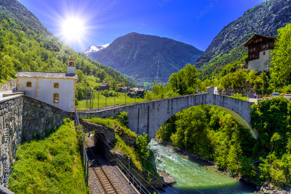 Ancient stone bridge over the moutnain river in Swiss Alps, Stal