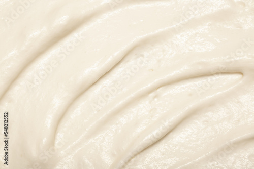 Cake cream texture, sweet whipped cream. Background of yogurt close-up with a pattern.