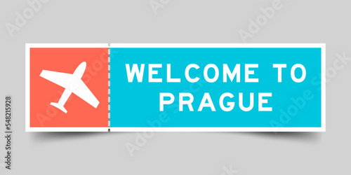 Orange and blue color ticket with plane icon and word welcome to prague on gray background
