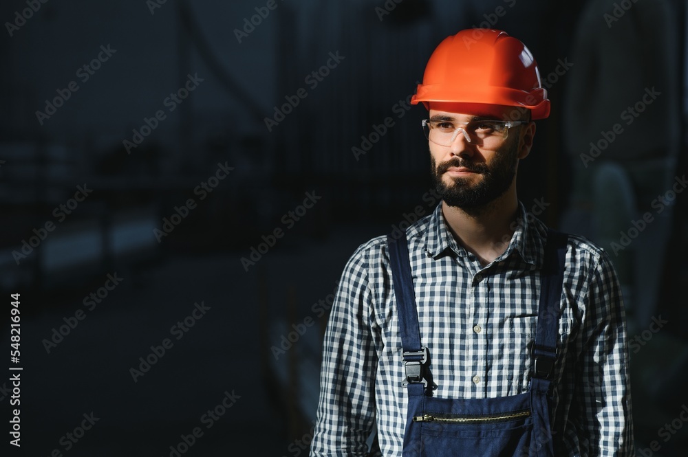 Portrait of industrial engineer. Factory worker with hard hat standing in factory. Portrait of industrial engineer. Factory worker with hard hat standing in factory.